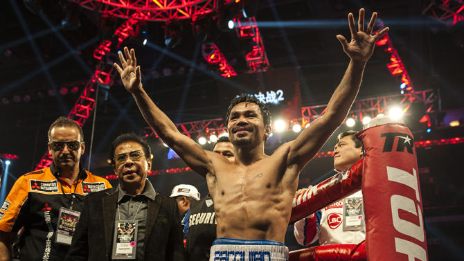 Philippine boxing legend Manny Pacquiao celebrates his victory over American Chris Algieri after their world welterweight championship boxing bout in Macau on November 23, 2014